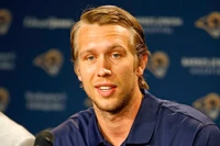 Quarterback at Press Conference with Focused Expression