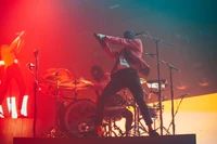 Dynamic Performance at a Rock Concert with Musicians in Red on Stage