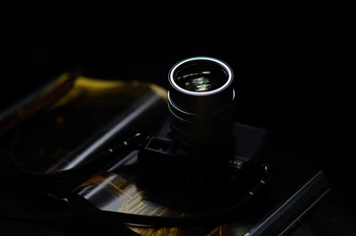 Illuminated Camera Lens on Dark Surface