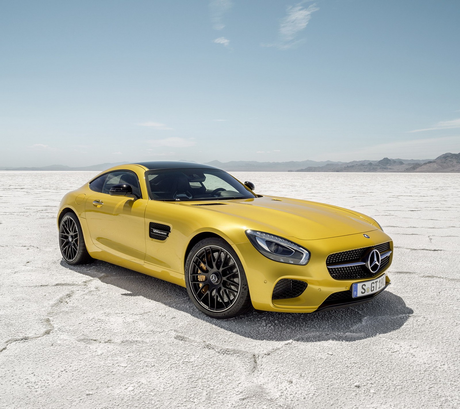 A yellow mercedes sports car parked in a desert area (car, mercedes)