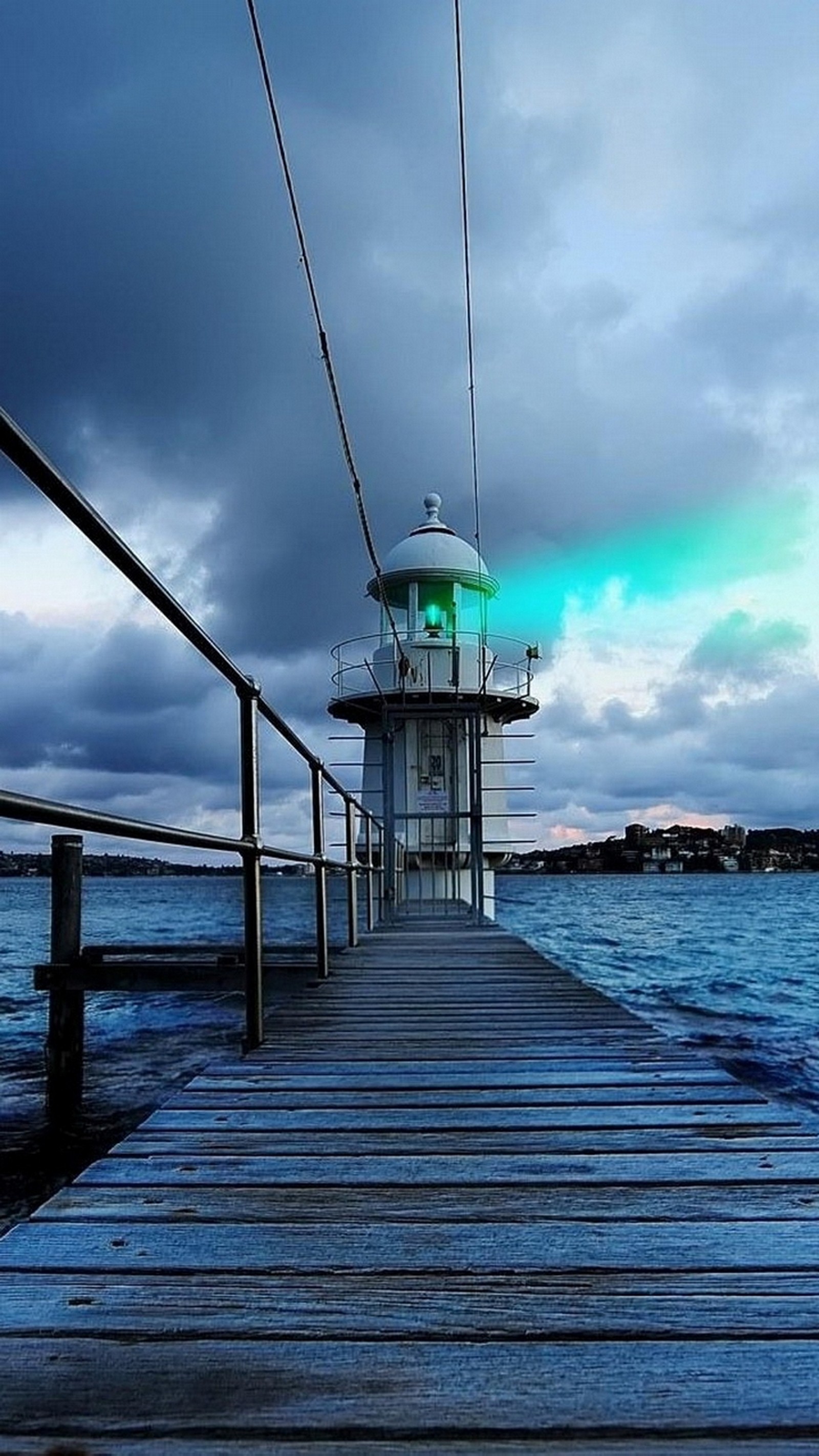 Arafed view of a pier with a light house on it (clouds, nature, sky, water)