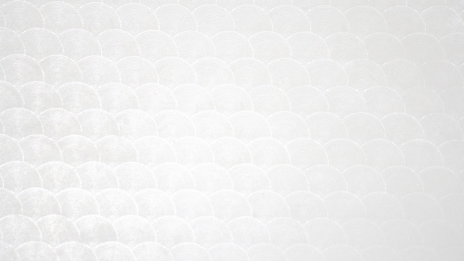 There is a white wall with a pattern of wavy lines (white, textile, texture, pattern, plastic)