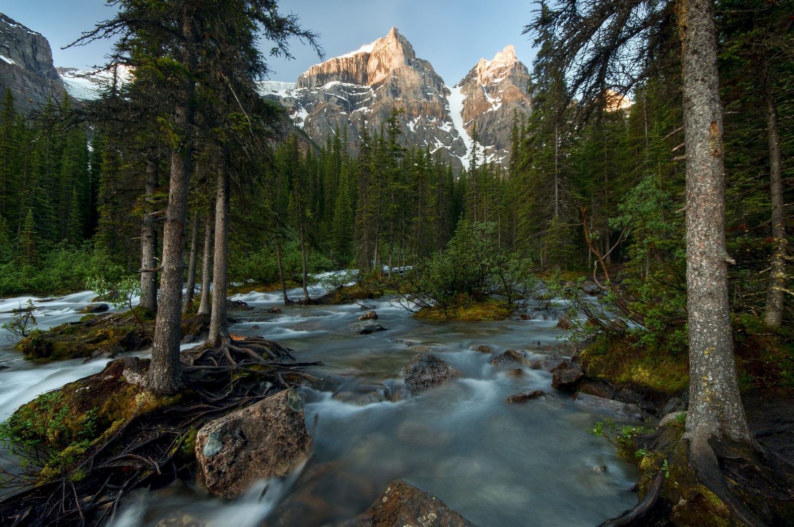 Arafed mountain in the distance with a stream running through it (landscape, nature, water, wilderness, stream)