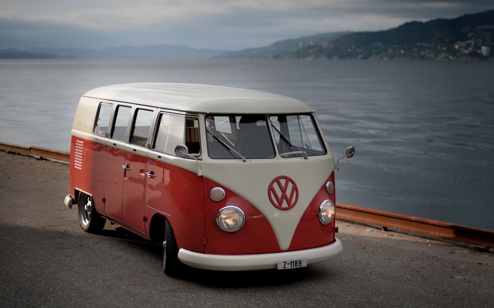 Arafed vw bus parked on the side of the road near the water (volkswagen type 2, volkswagen, van, car, transport)