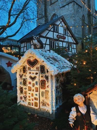 Charming Gingerbread Cottage Adorned with Holiday Lights and Decorations