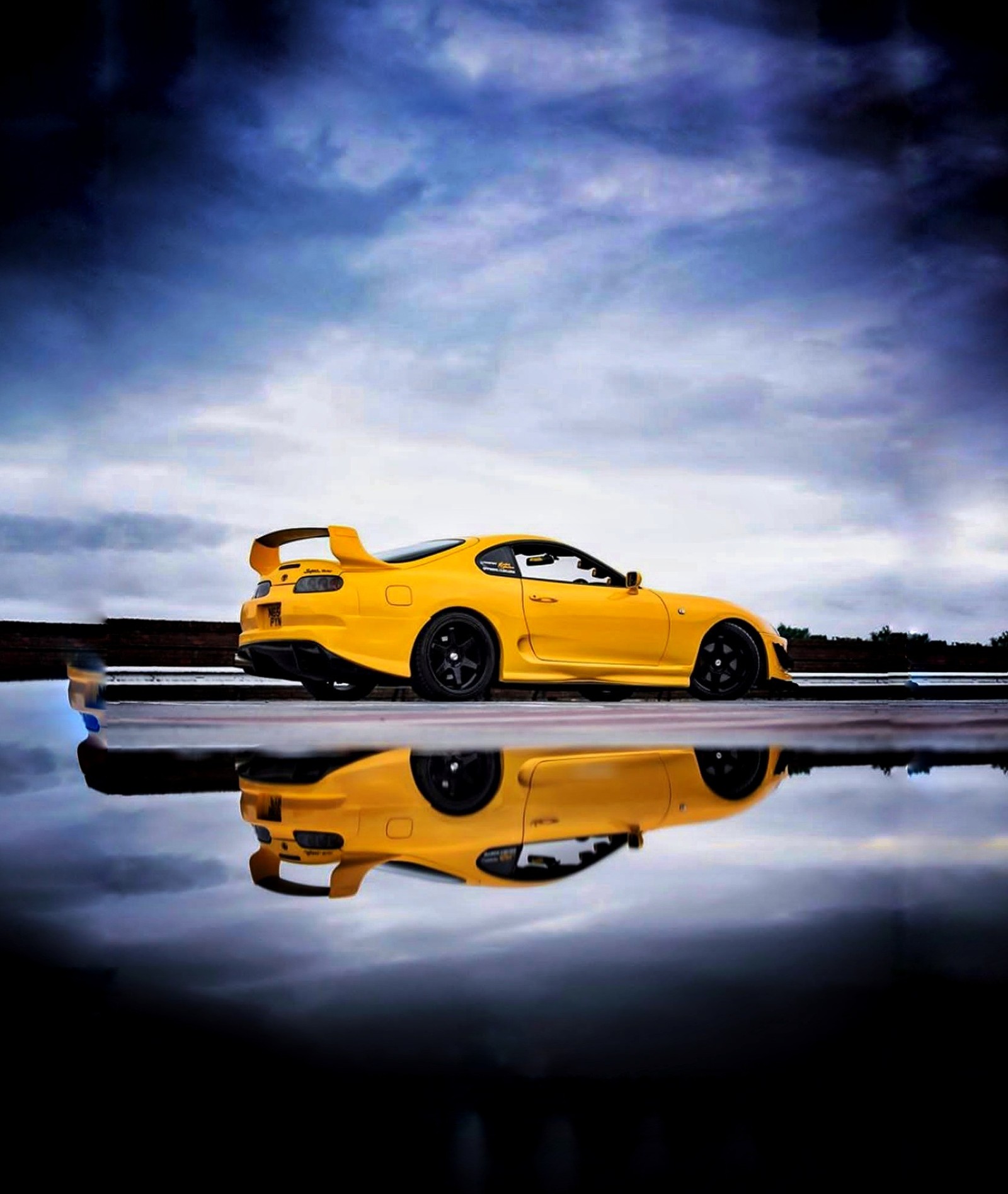 A close up of a yellow sports car parked on a road (auto, car, love, racing, sound)