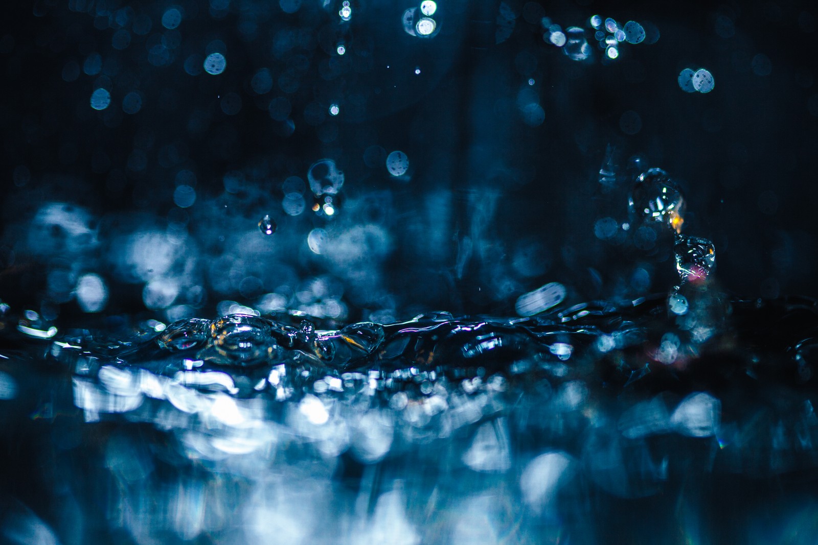 A close up of a water droplet with a blue background (water, liquid, azure, fluid, moisture)