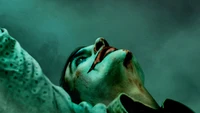 A haunting portrayal of the Joker, showcasing Joaquin Phoenix's intense expression and eerie atmosphere.