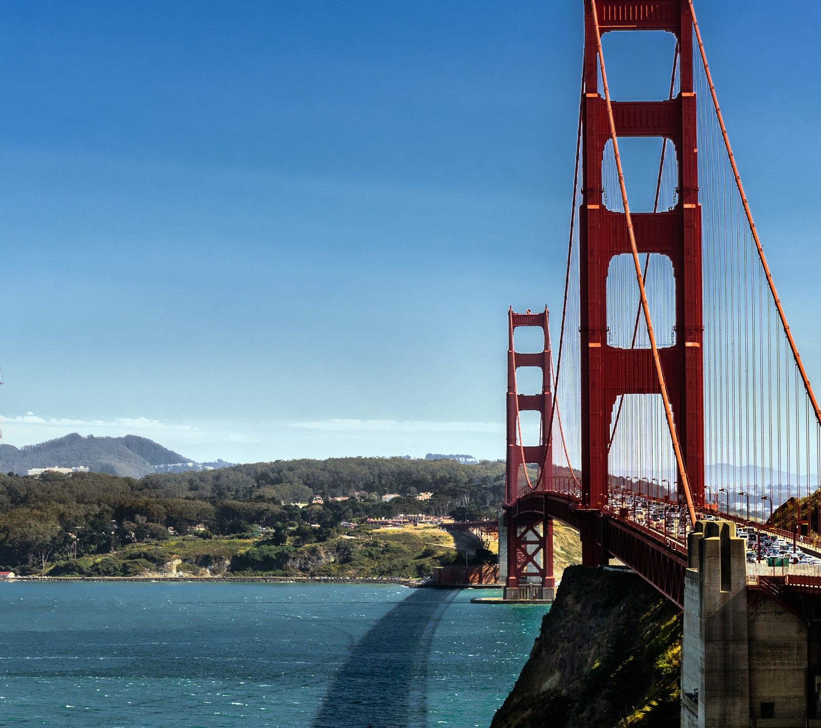 Arafed view of a bridge with a boat going under it (bridge, california, gate, golden, san francisco)