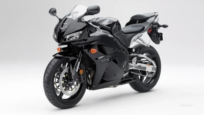 Moto sportive Honda CBR noire avec carénage élégant et design moderne, mettant en avant les caractéristiques de la série Honda CBR.