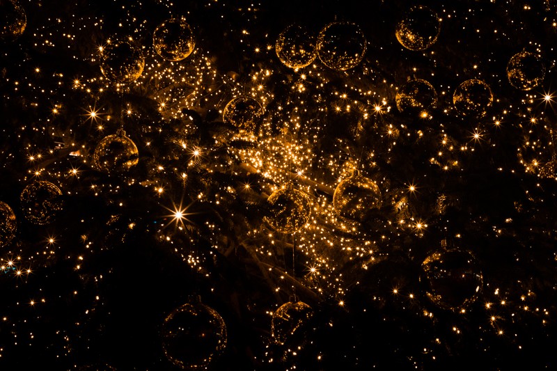 A close up of a city at night with lots of lights (christmas day, water, space, astronomical object, darkness)