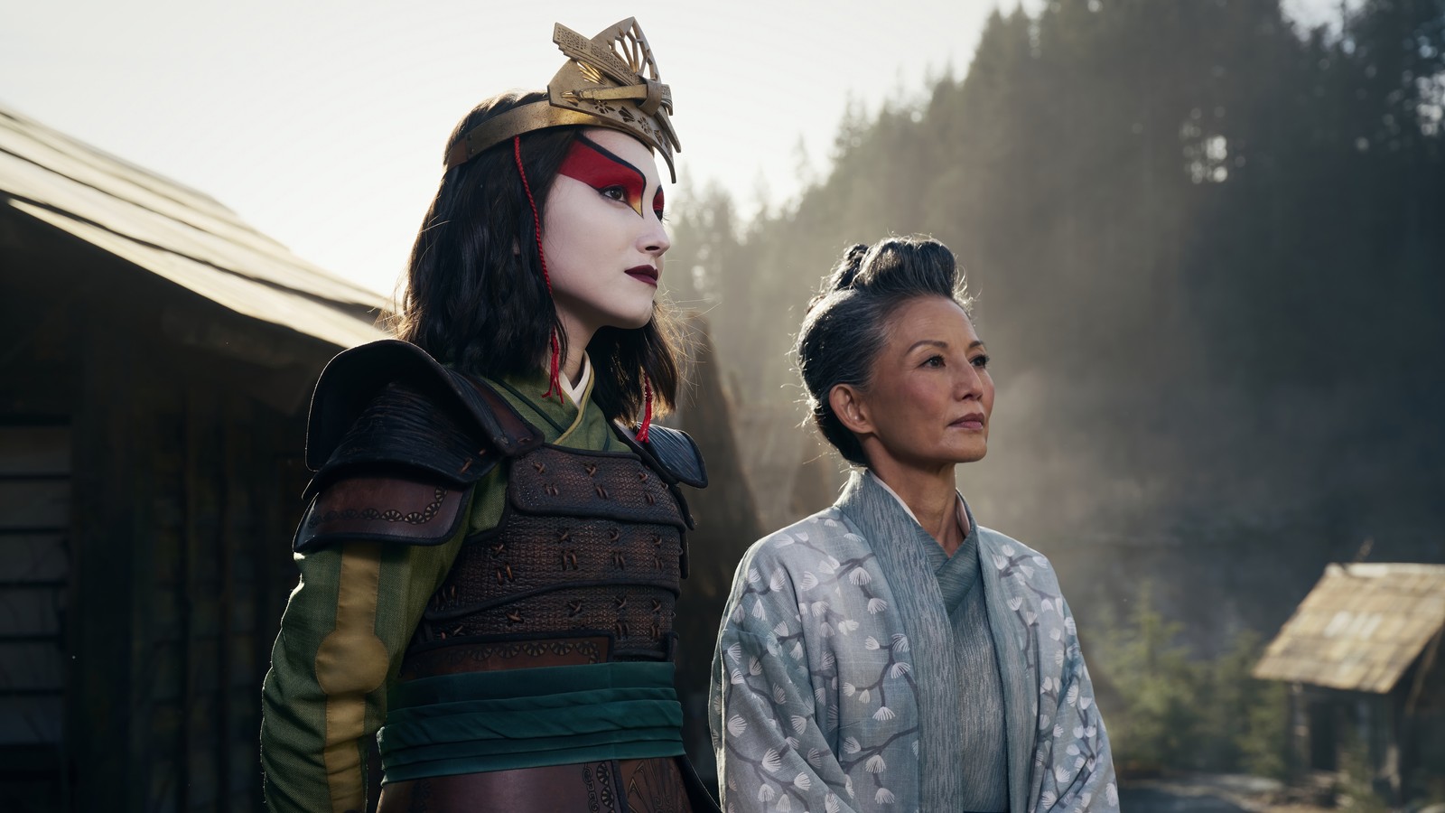 Two women in costumes standing next to each other in a field (avatar the last airbender, netflix, live action, tv series, zuki)