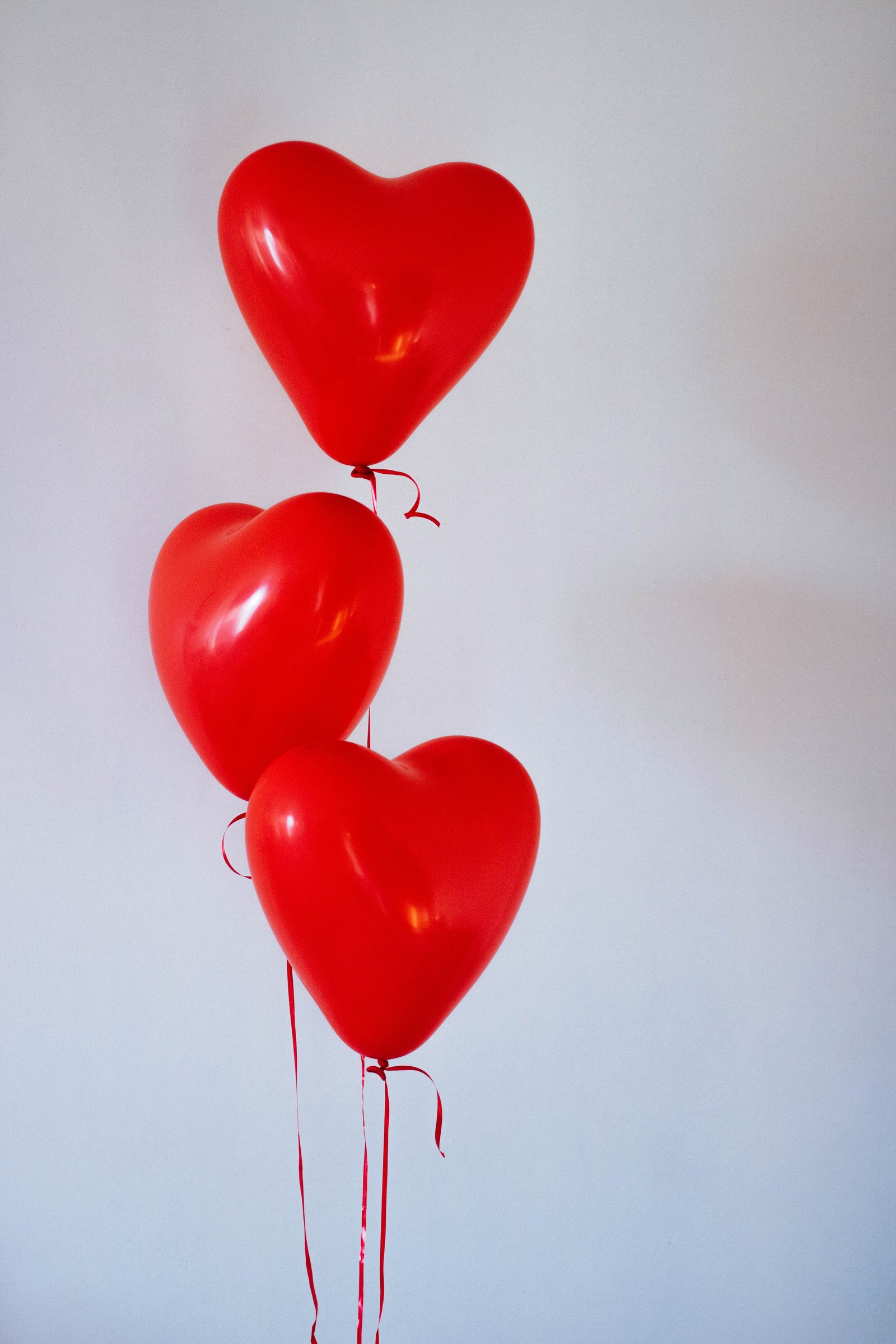 Il y a trois ballons rouges en forme de cœur (ballon, rouge, cœur, fête, ballon jouet)