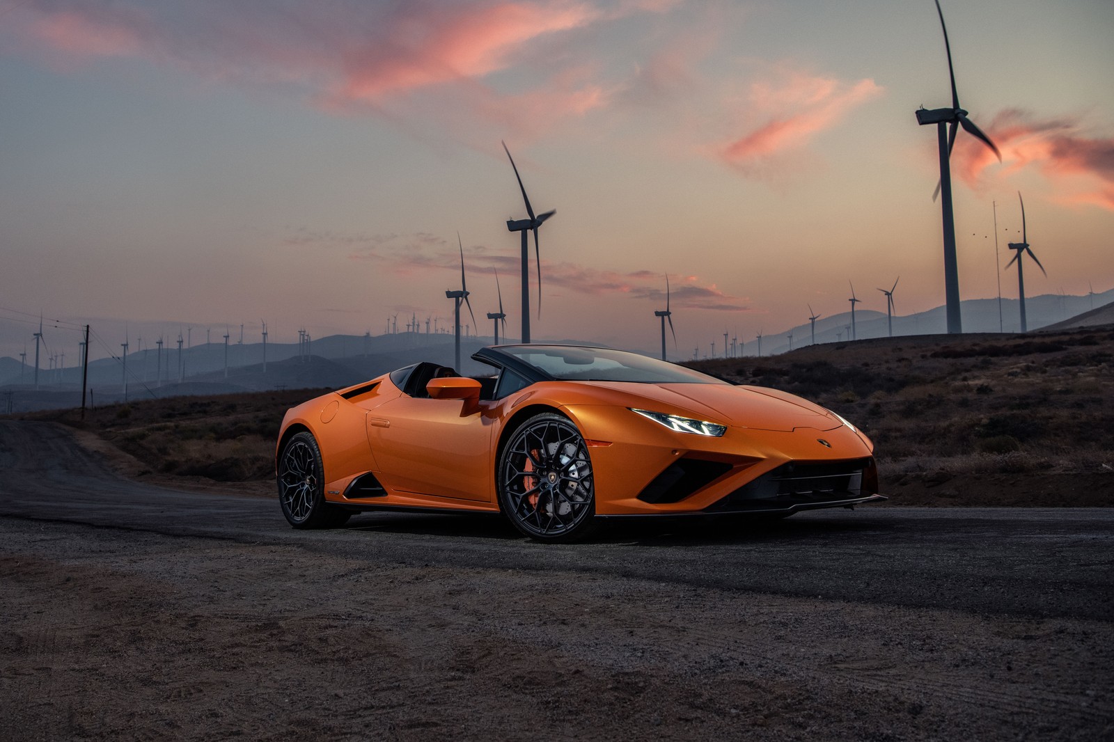 A close up of a lamborgon parked on a road near wind turbines (lamborghini huracan evo rwd spyder, 2021, 5k, cars, 4k wallpaper)