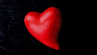 Red Heart Symbolizing Love Against a Dark Background