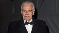 Elegant gentleman with facial hair in a tuxedo, embodying the timeless charm of classic cinema.