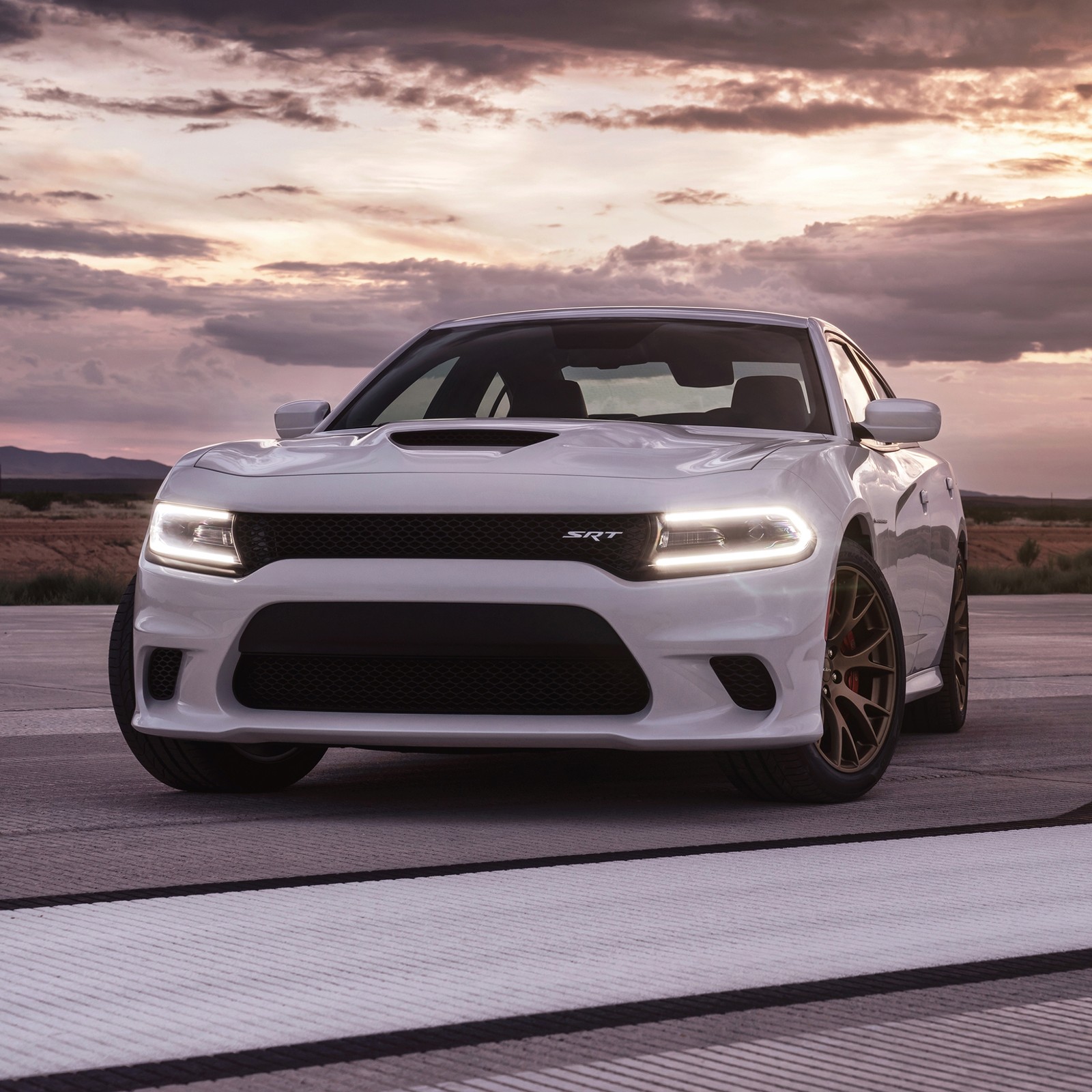 A white dodge charger parked on a road with a sunset in the background (auto, car, charger, dodge, hellcat)