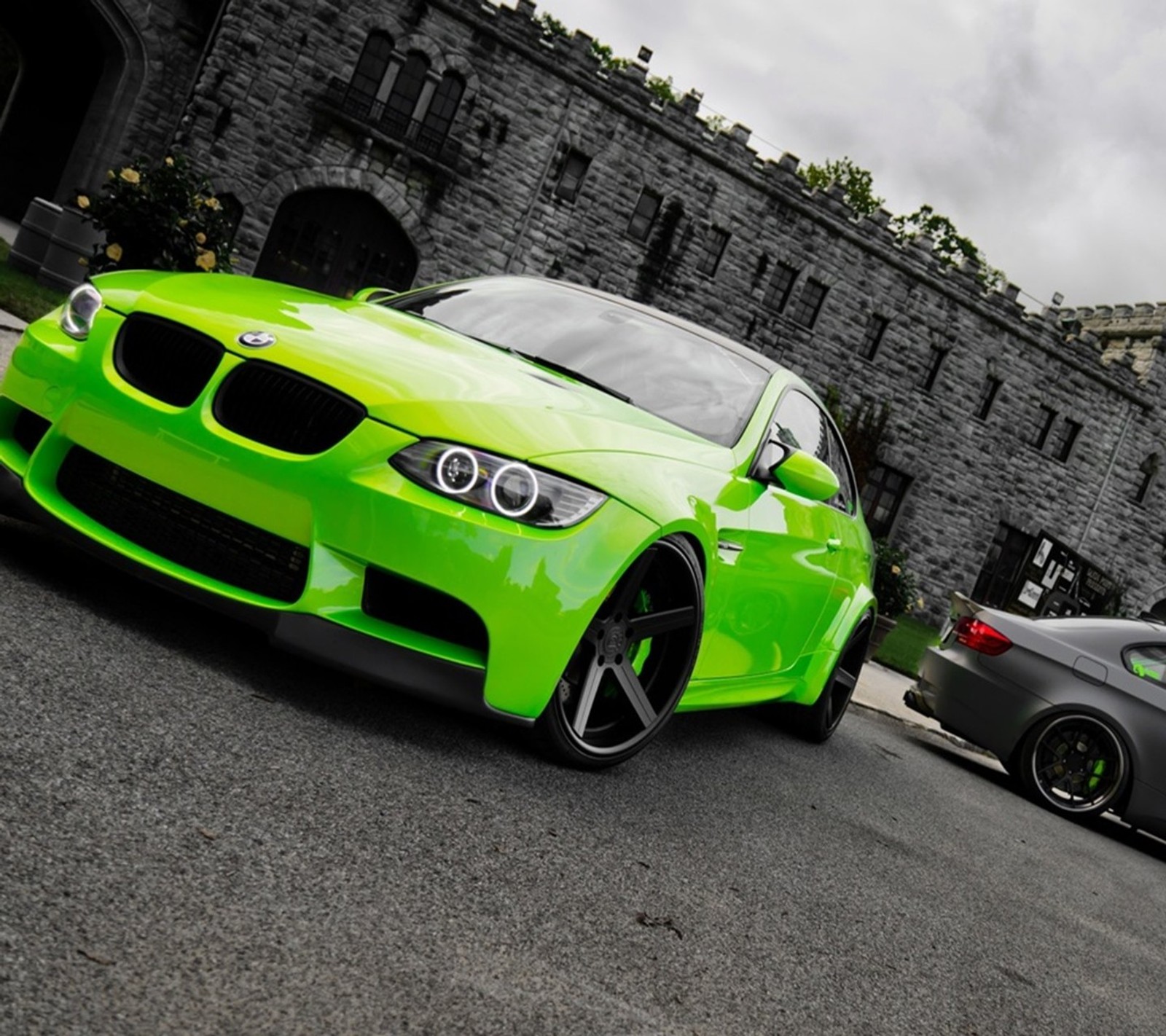 A close up of a green bmw car parked in front of a castle (bmw, car, classic, green, new)