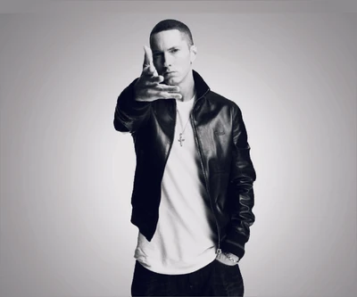 Eminem in a black leather jacket, extending his hand towards the viewer.