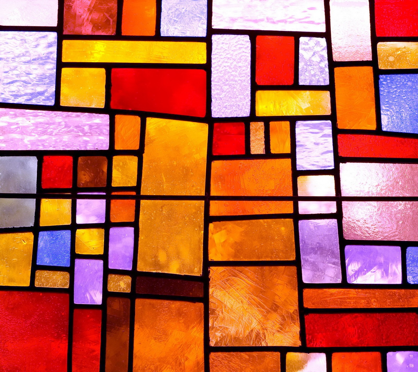 A close up of a stained glass window with a red, yellow, blue and purple design (colorful, glass, stained, window)