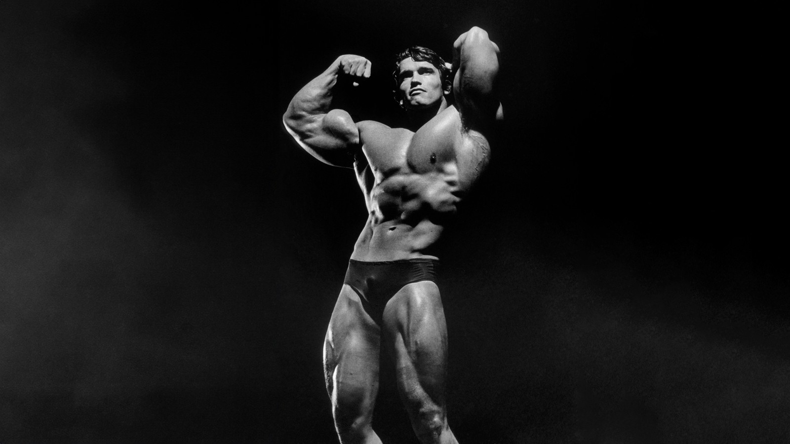 Arafed bodybuildeer flexing his muscles in a black and white photo (arnold schwarzenegger, bodybuilder, dark background, monochrome, 5k)