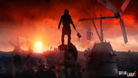 A lone figure stands triumphantly on a statue, wielding a weapon against a backdrop of a dramatic sunset, silhouetted by windmills and the ominous shadows of a post-apocalyptic cityscape.