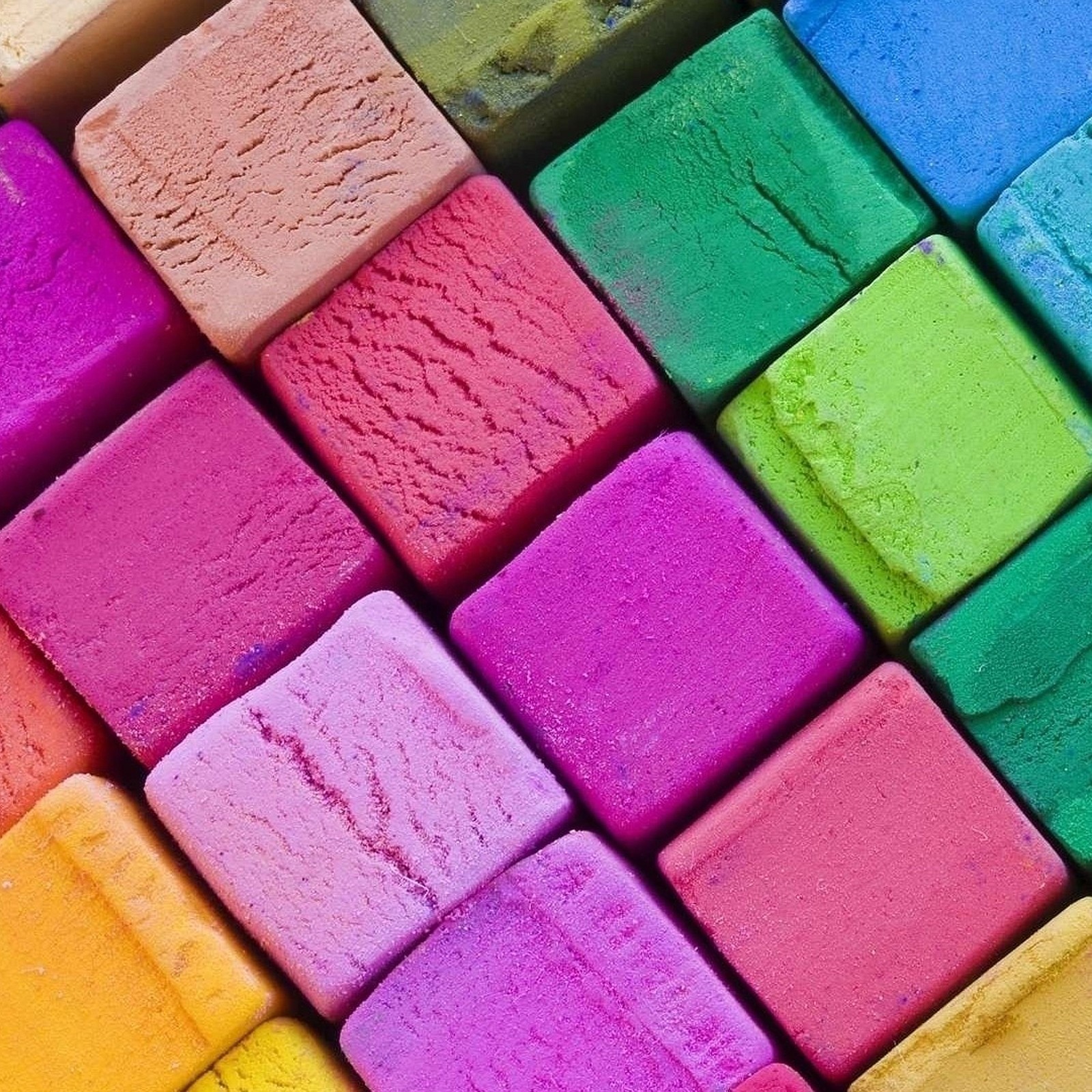 A close up of a box of colored chalks with a wooden handle (colour, food, ice, shape, square)