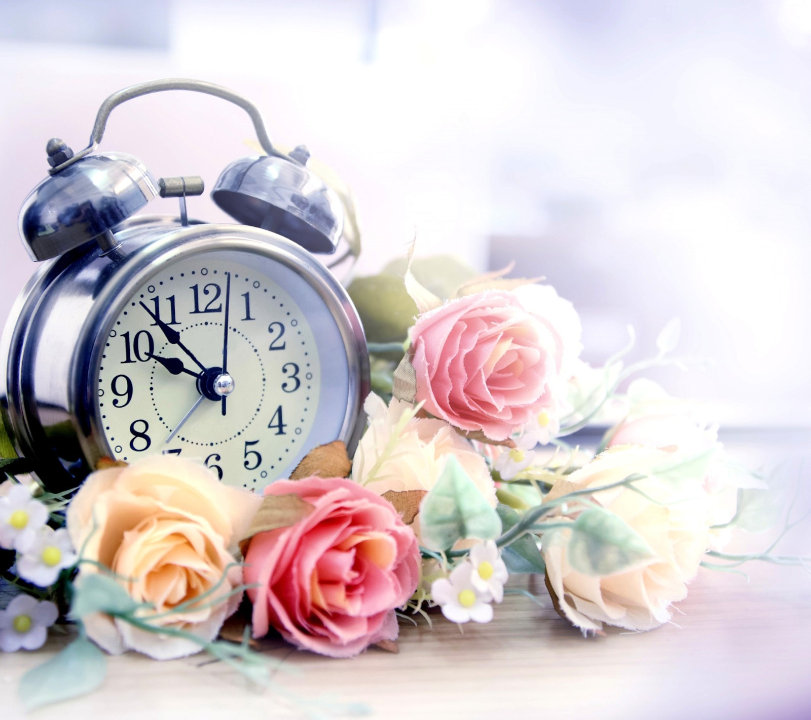 There is a clock with flowers on the table next to it (beautiful, flowers, hd, wallpapers)