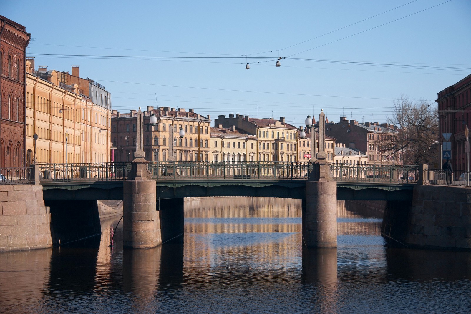 Eine luftaufnahme einer brücke über einen fluss mit gebäuden im hintergrund (brücke, wasser, wasserstraße, fluss, kanal)