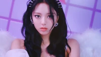 Yuna from ITZY exudes elegance and charisma in a vibrant, dreamy setting, showcasing her captivating presence in the "Loco" music video.