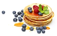 Delicious Pancakes Topped with Fresh Berries and Maple Syrup