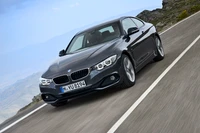 Sleek BMW 3 Series Coupé with Alloy Wheels on a Scenic Road