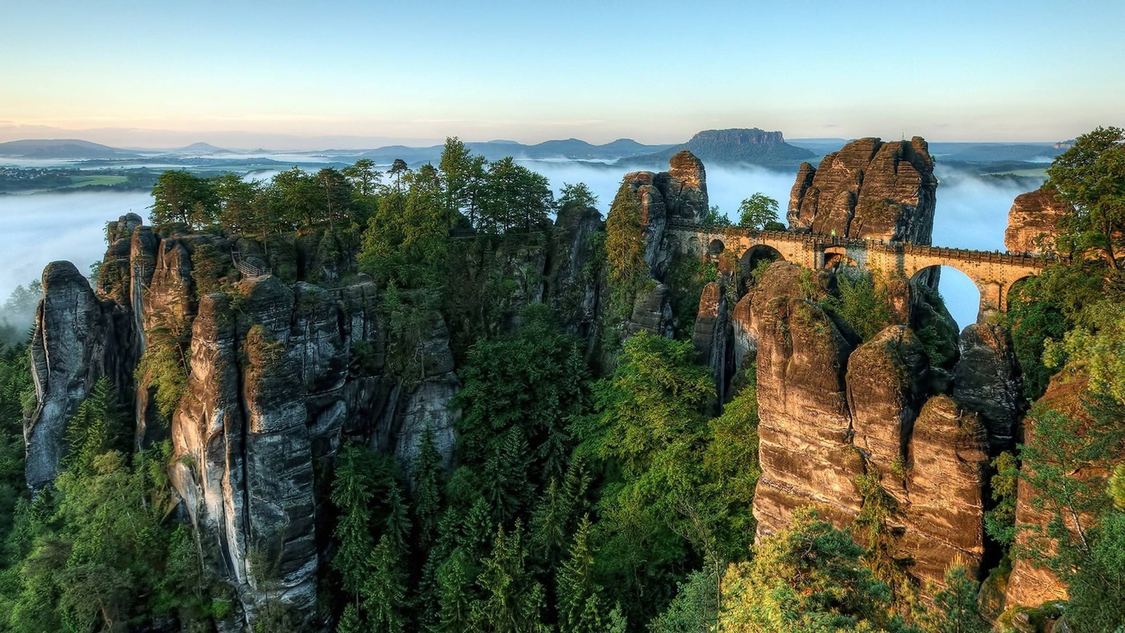 A view of the mountains and a bridge in the distance (national park, elbe, nature, rock, formation)