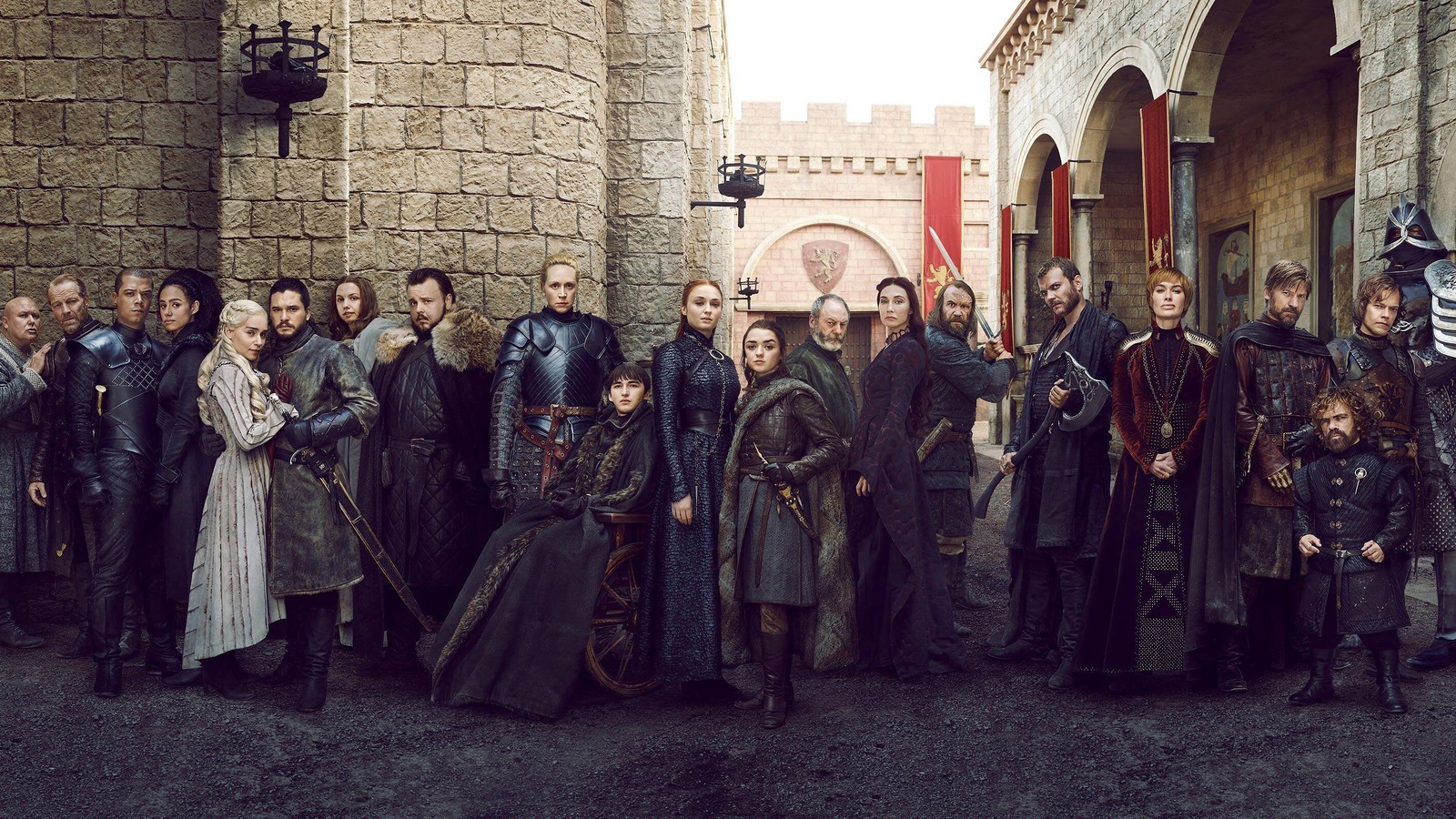 Um grupo de pessoas vestidas com roupas medievais em frente a um castelo (game of thrones)