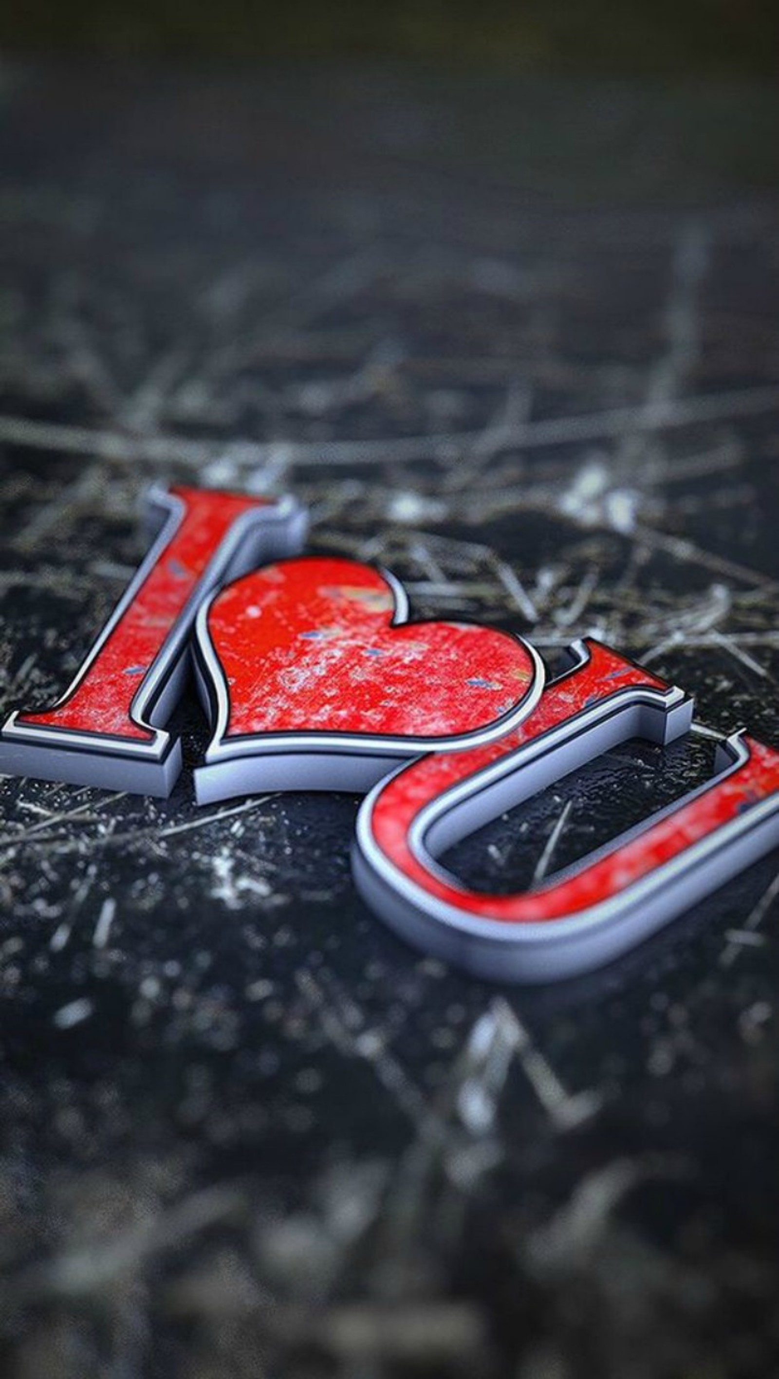 A close up of a red and black letter on a marble surface (heart, i love you, love, valentines day)