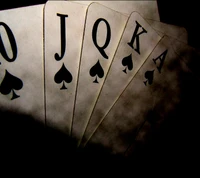 A royal flush in spades displayed on playing cards.