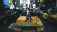 A child sits on a yellow taxi in a futuristic, bustling cityscape filled with vibrant neon advertisements and traffic.