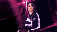 Selena Gomez in a stylish Puma hoodie, exuding confidence and glamour.