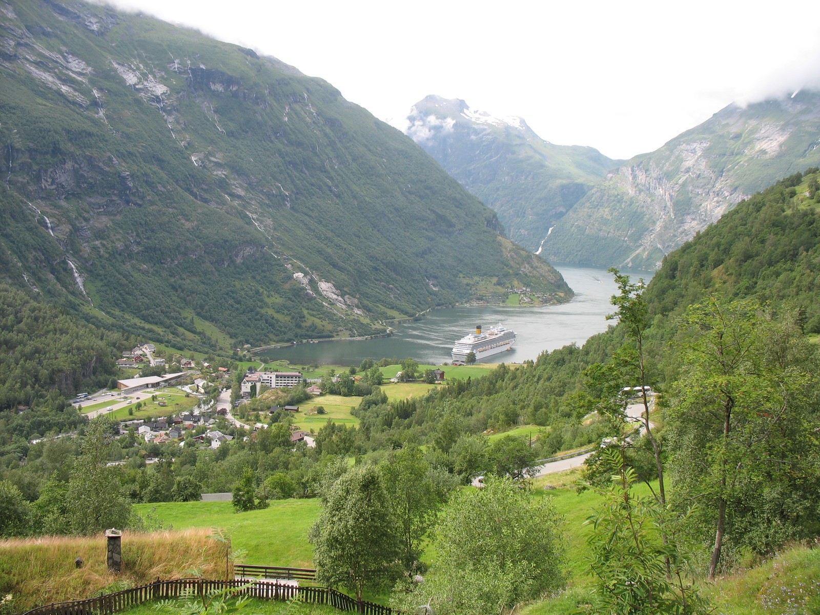 Arafed view of a valley with a river and a village (highland, fjord, alps, valley, mountain)