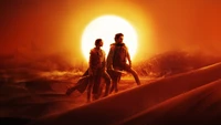 Timothée Chalamet como Paul Atreides e Zendaya como Chani em uma deslumbrante cena de pôr do sol no deserto de Duna 2