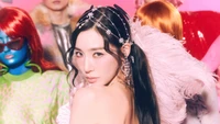 Tiffany Young from Girls' Generation showcasing a striking pose amidst vibrant, colorful backgrounds and fellow performers.