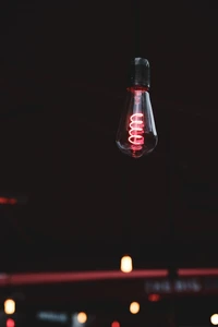 Red Glass Light Fixture Illuminating a Dark Room