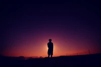 Alone in the Evening: A Boy Embracing the Dark Orange Horizon