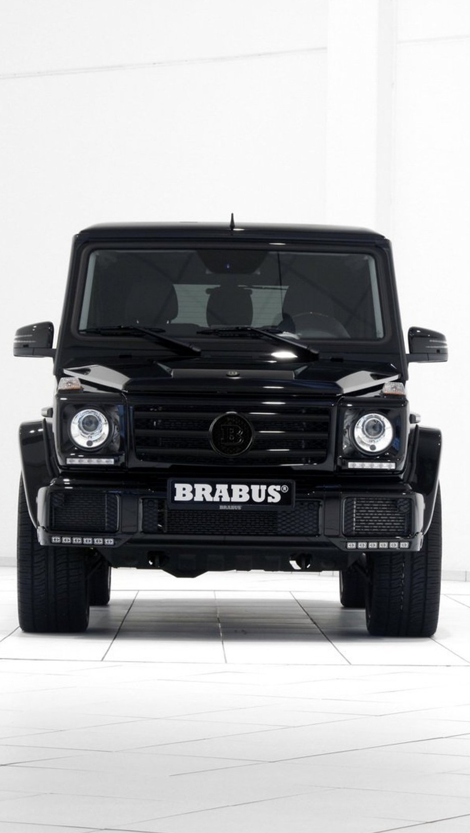 Arafed black mercedes g - class parked in a white room (brabus, car, luxury, mercedes)