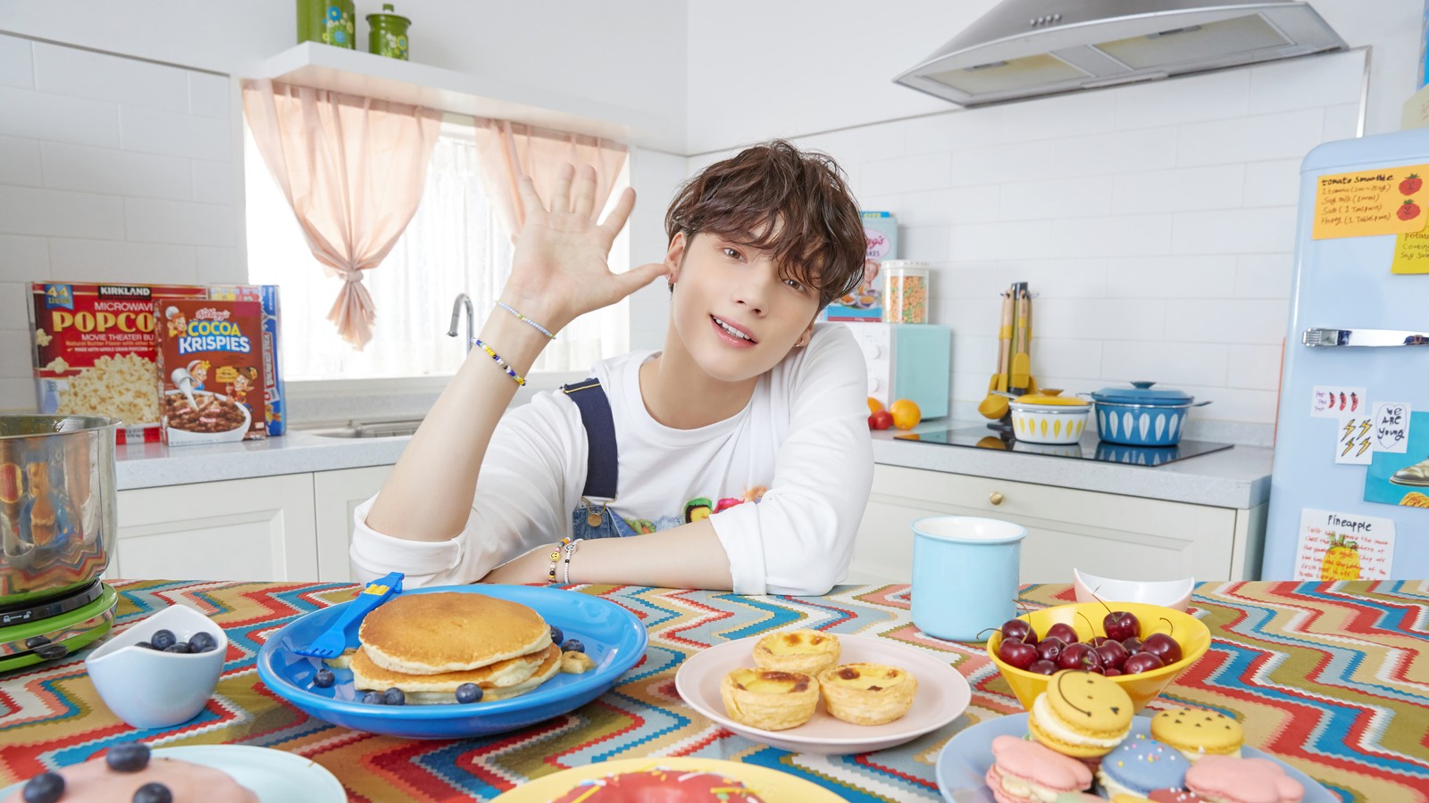 Il y a un homme assis à une table avec une assiette de nourriture (txt kpop, tomorrow x together, 투모로우바и투게더, 투모로우바이투게더, kpop)