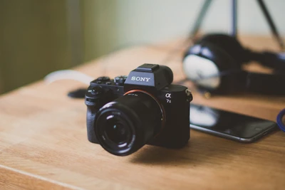 Sony Alpha 7I Camera with Lens on Wooden Surface