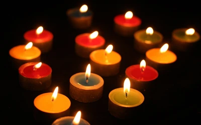 Colorful Candles Illuminating a Dark Space