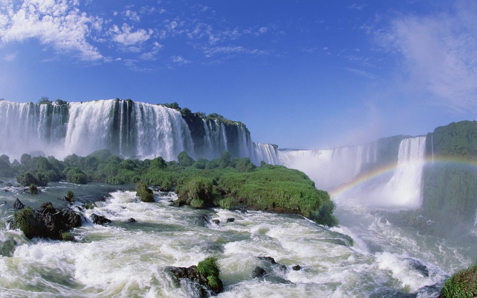 Arafed view of a rainbow over a waterfall with a rainbow in the sky (iguazu falls, waterfall, tourist attraction, water resources, body of water)