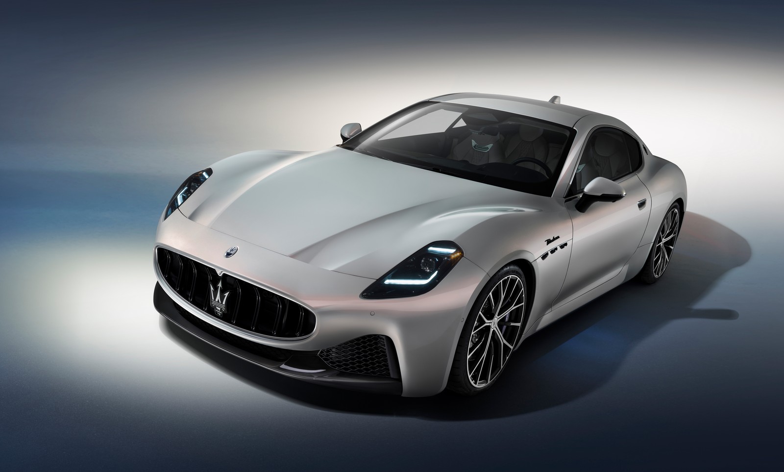 A silver mas car is shown in a studio setting (maserati granturismo modena, 2023, 5k, 8k, cars)