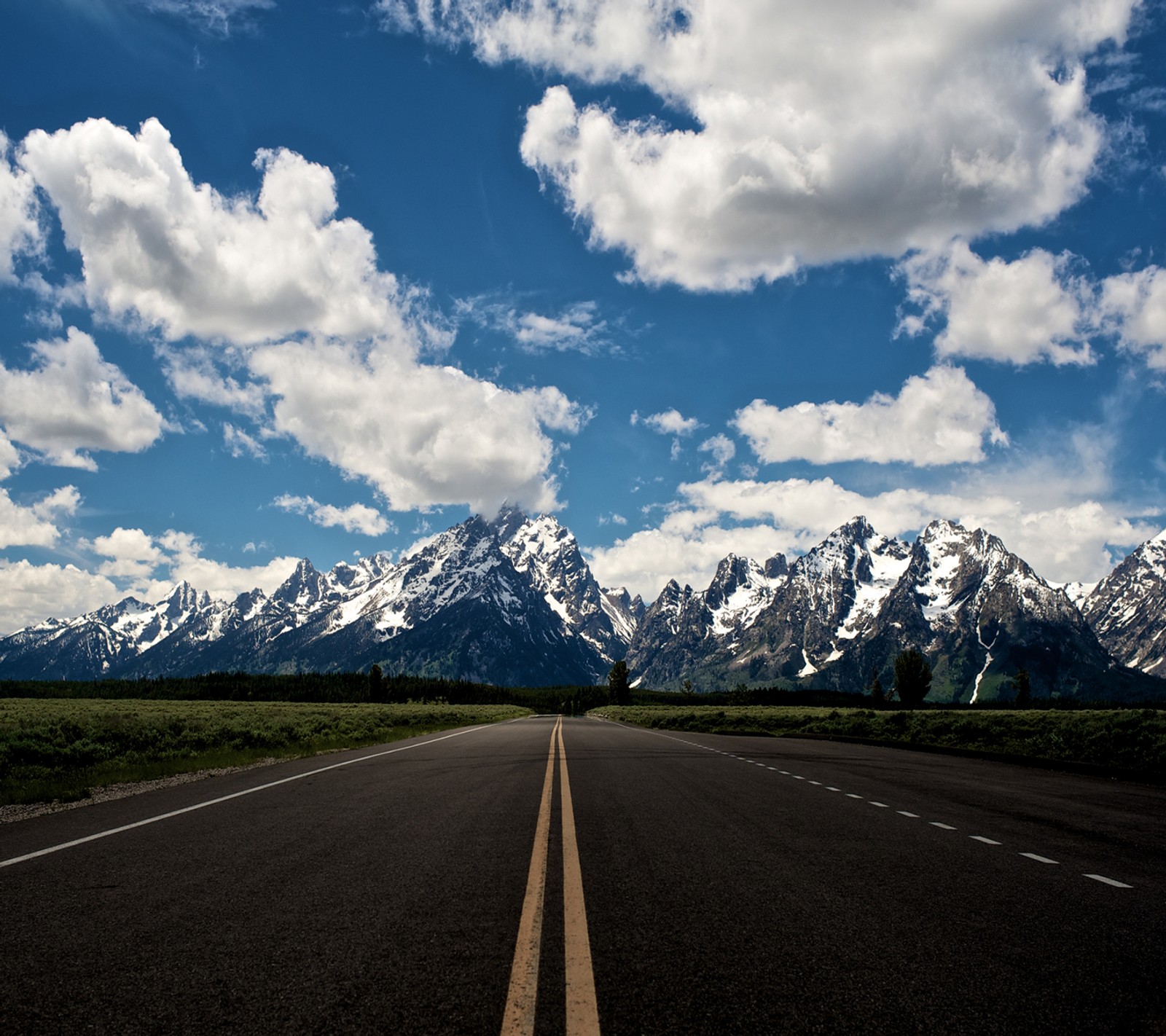 Arafed road with mountains in the background and a blue sky (nature, nexus, road to the sky, wallpaper)